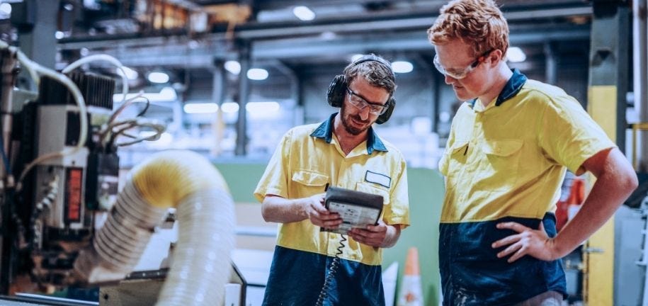 Zwei Techniker überprüfen die Steuerung der Industrieanlage